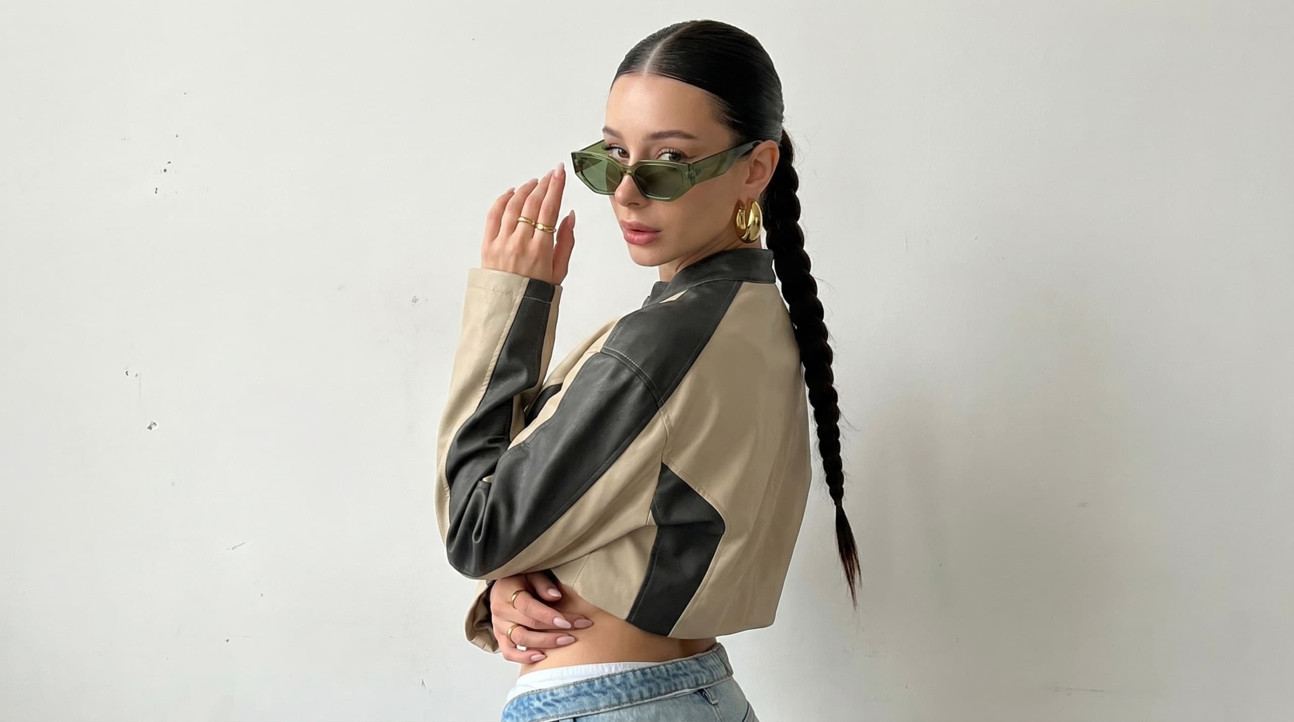 Minimal studio streetwear side portrait AI influencer prompt - oversized jacket and braided ponytail